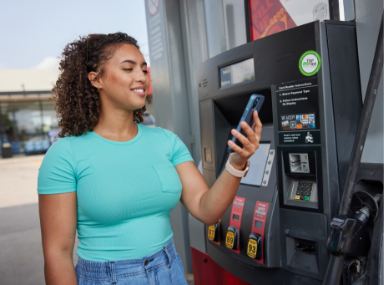Lady at the pump using app