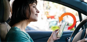 Lady in driver seat with phone in hand